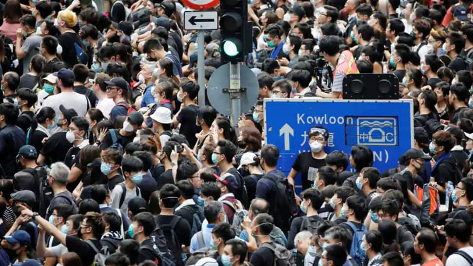 Hong Kong leader says stability restored, riot police on alert over banned protest march