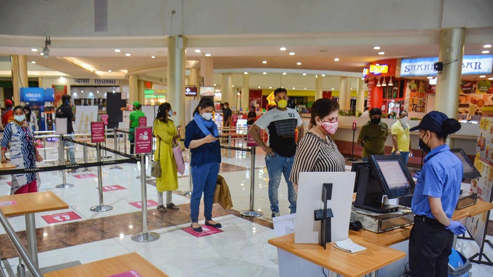 People stand in a queue at a fast-food takeaway in India