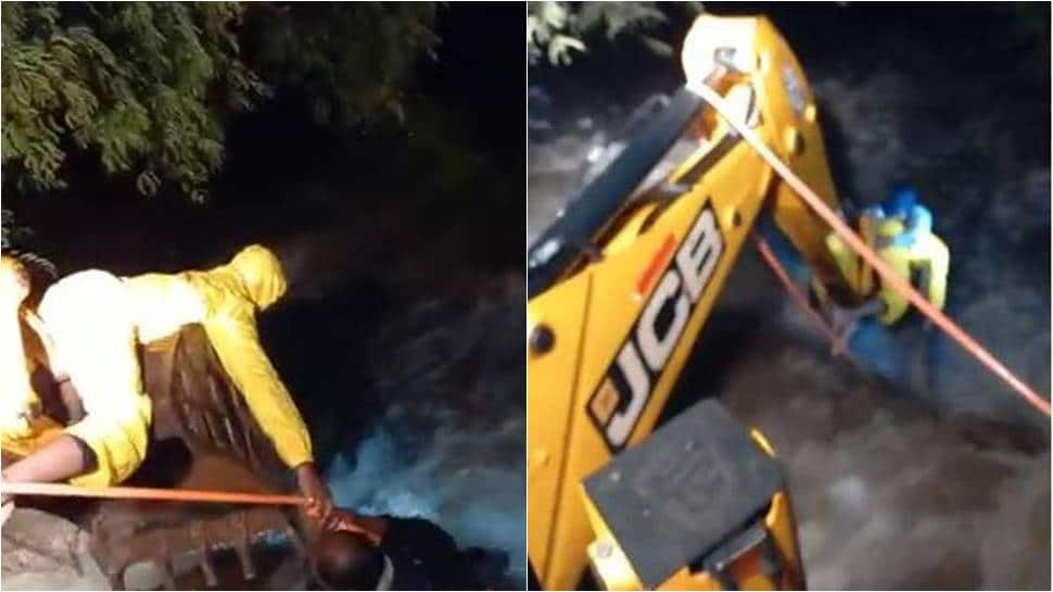 Pune man washed away in rain water rescued with help of JCB: WATCH