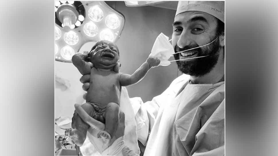 Positivity in 2020! Viral picture of newborn baby removing doctor’s mask wins hearts