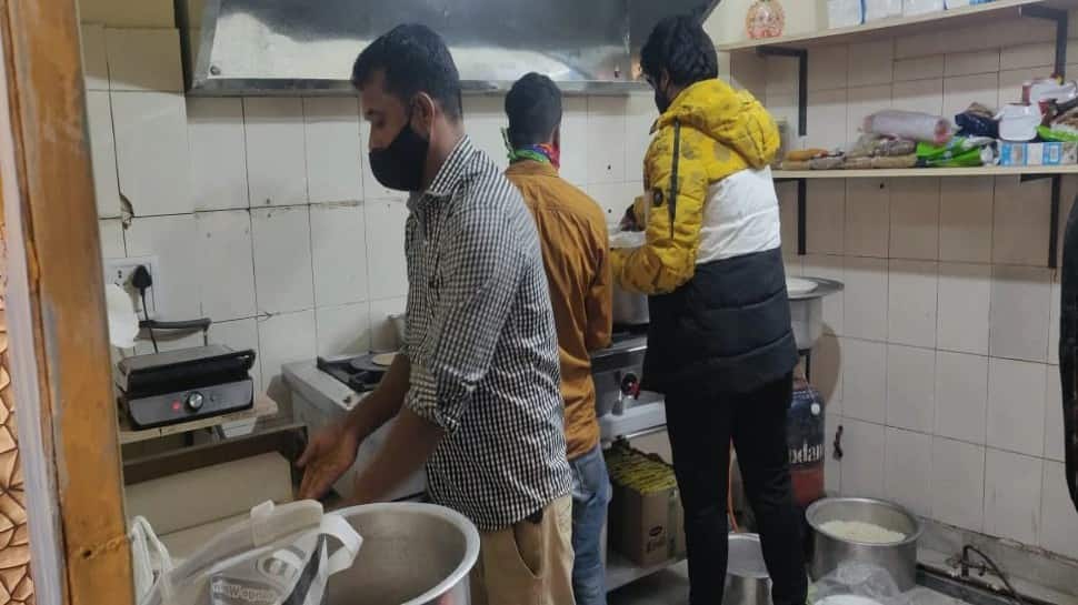 Staff help Baba run his restaurant smoothly