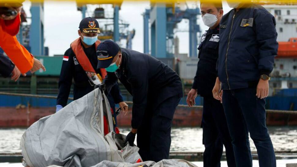 Indonesia finds body parts, debris, detects emergency signal of crashed jet