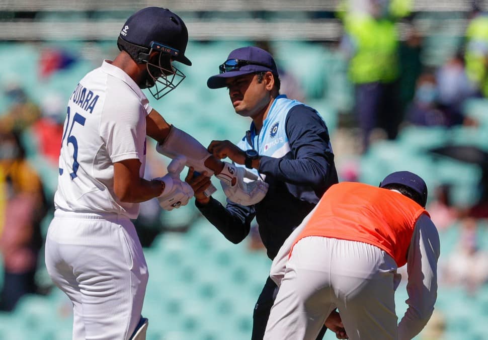 Indian team physio treats Cheteshwar Pujara for an injury.