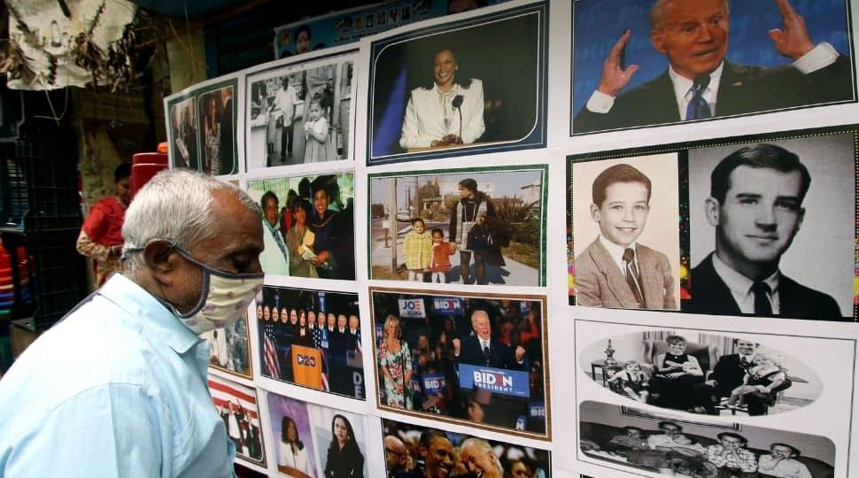 A shopkeeper displays the pictures of US President Joe Biden and Vice President Kamala Harris, in Chennai