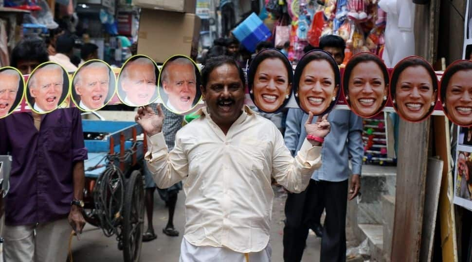 A man wears a mask of US President Joe Biden and Vice President Kamala Harris in Chennai