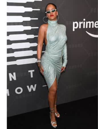 Rihanna flaunts her svelte figure in a shimmering dress!