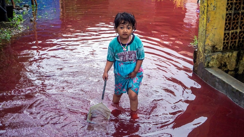 Indonesian village turns red as floods hit batik factory- See pic