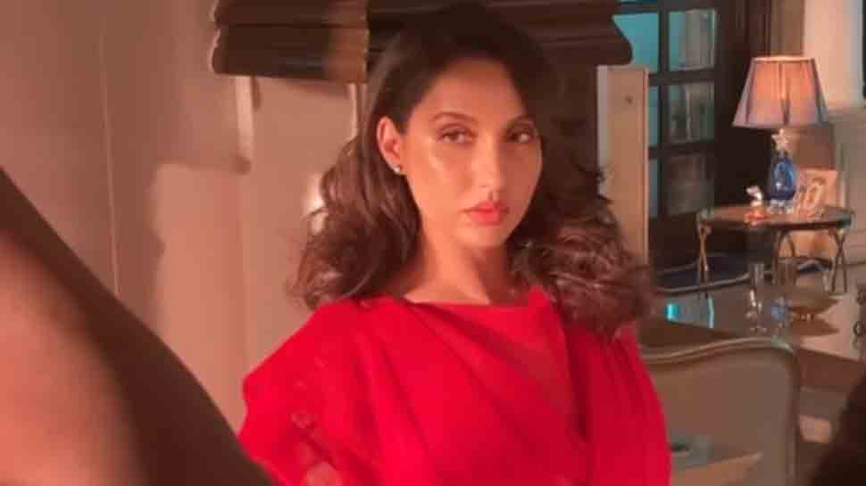 Nora Fatehi strikes killer pose, looks magnificent in a red saree, shares video from photoshoot 