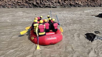 SDRF teams rowing in the river looking for survivors