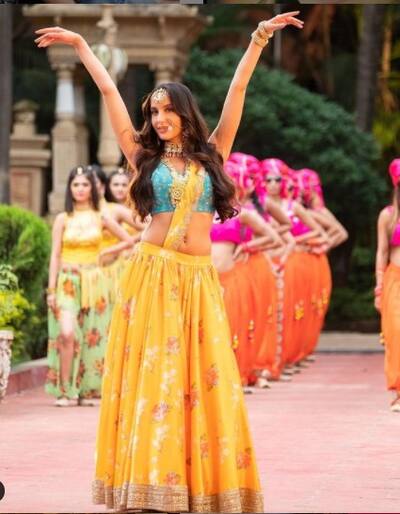 Nora dazzles in this yellow and blue lehenga