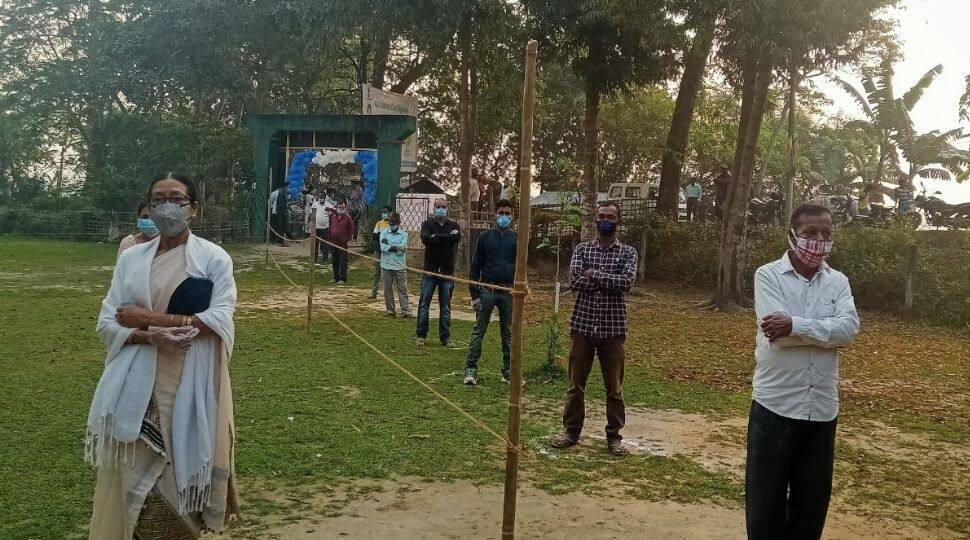 Voters follow physical distancing at a polling station set up at Kamala Bari Junior Basic School, Majuli in Assam.