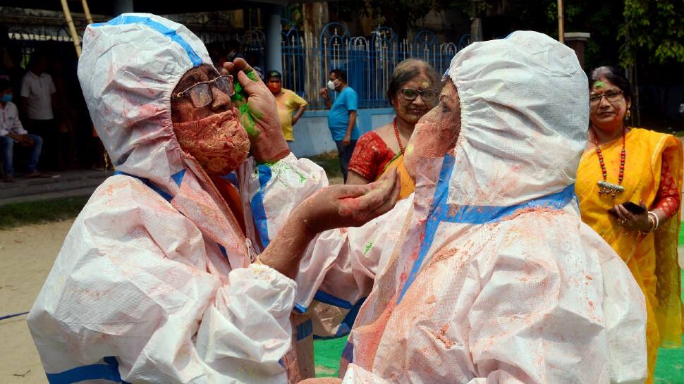 Two civilians wore PPE kits to celebrate Holi the safe way