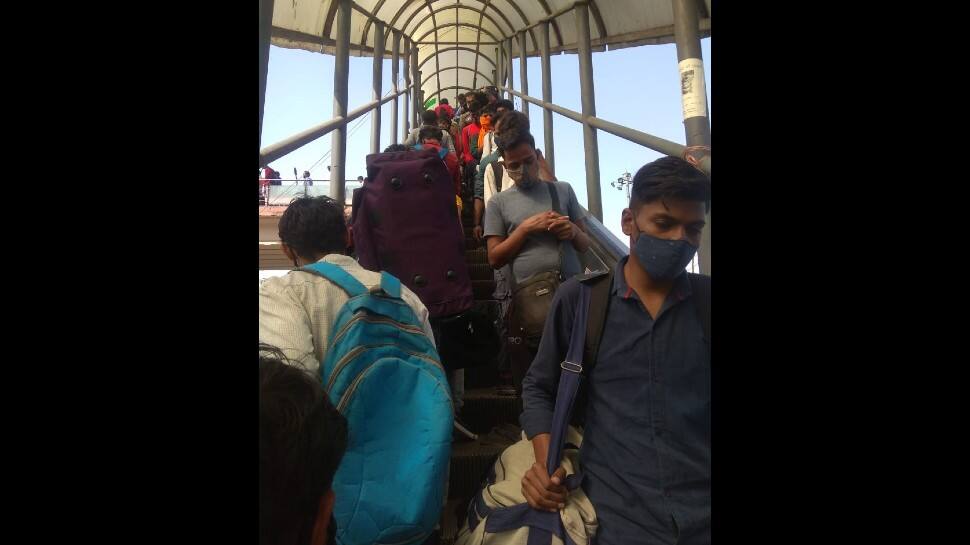 Migrant labourers rush to the metro station after COVID-19 Delhi lockdown announcement