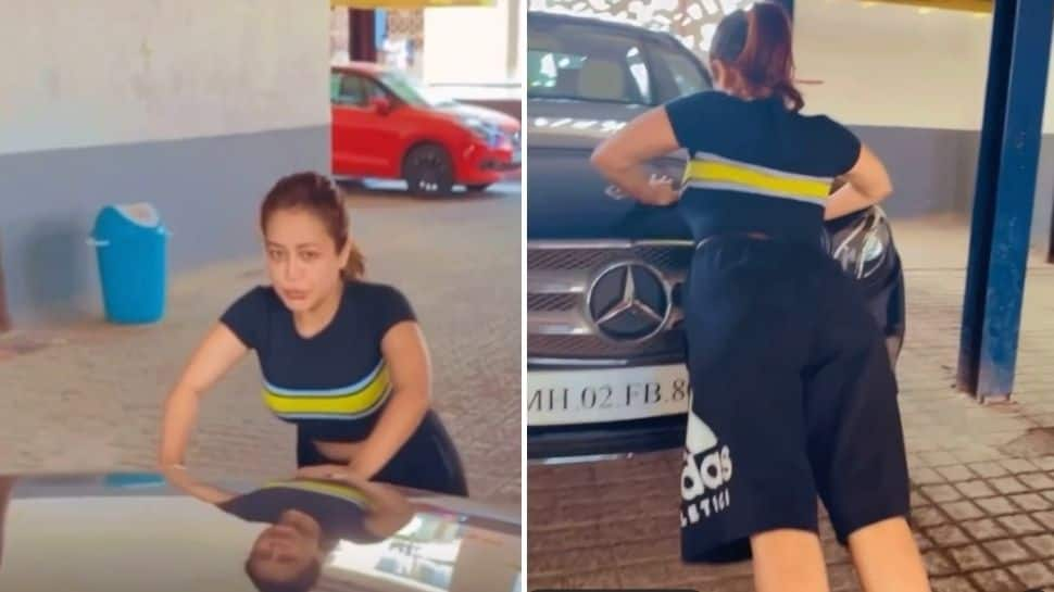 Neha Kakkar turns her parking lot into gym, does push-ups on her Mercedes! - WATCH