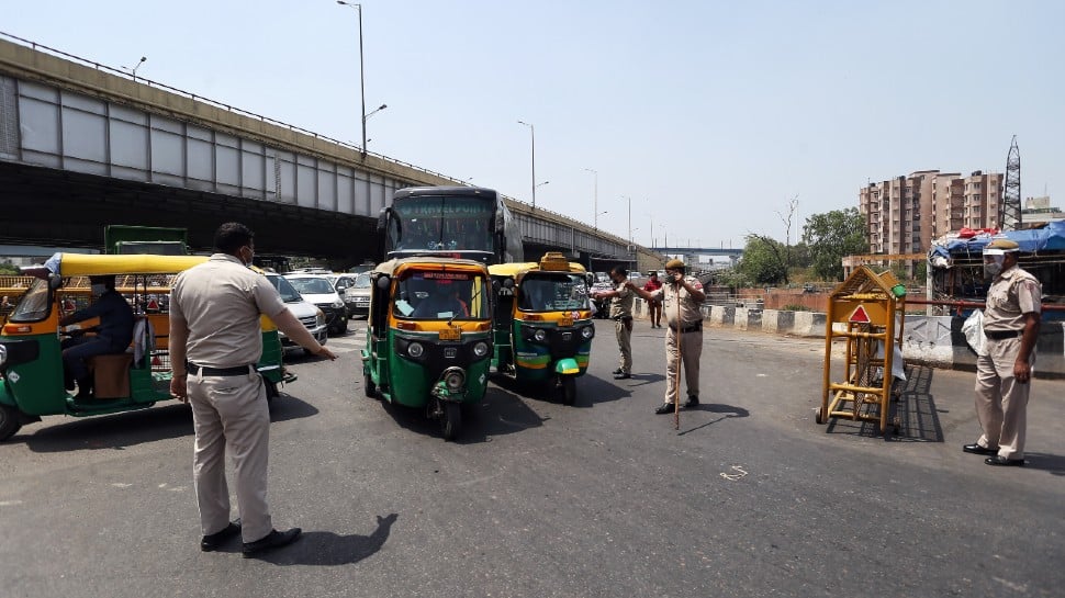 Security personnel check vehicles during the lockdown in Delhi