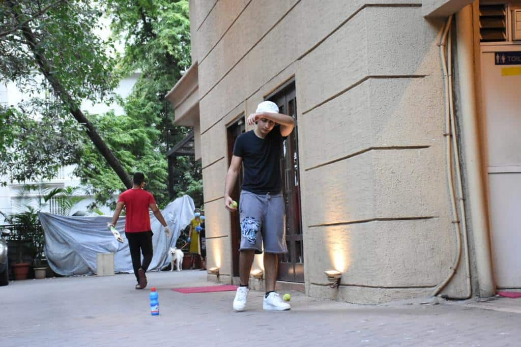 The star kid sports a white cap to beat the heat