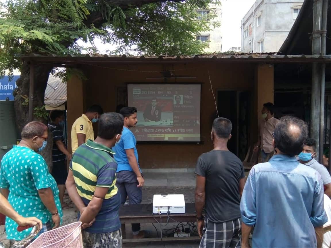 People set up a public viewing screen to watch the counting of the West Bengal elections live