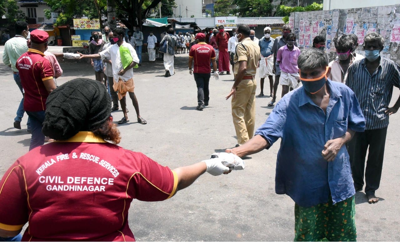 Civil Defence workers provide food to people during COVID lockdown in Kochi