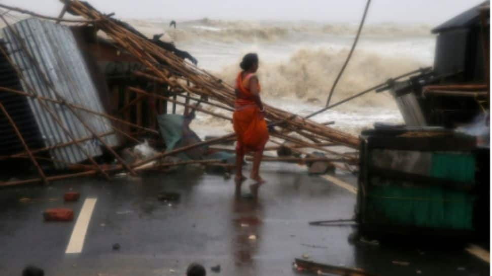 Woman looks at her damaged stall in Odisha by Cyclone Yaas