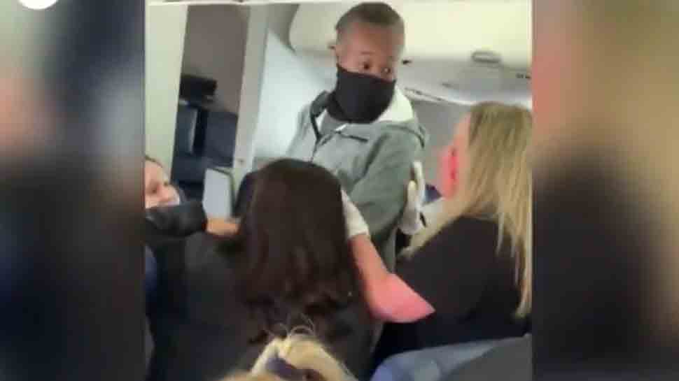 Brawl mid-air! Flight attendant punched in face, left with broken teeth,  video goes viral | viral News | Zee News