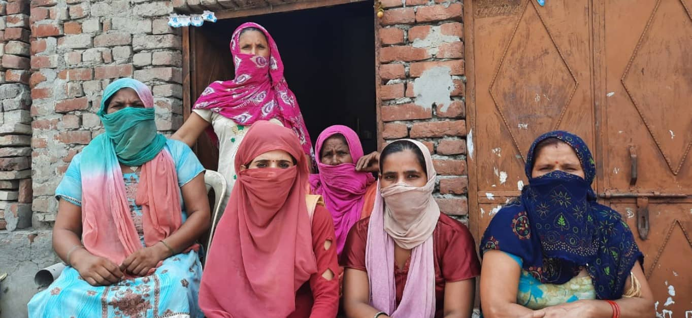 Women sitting outside their houses