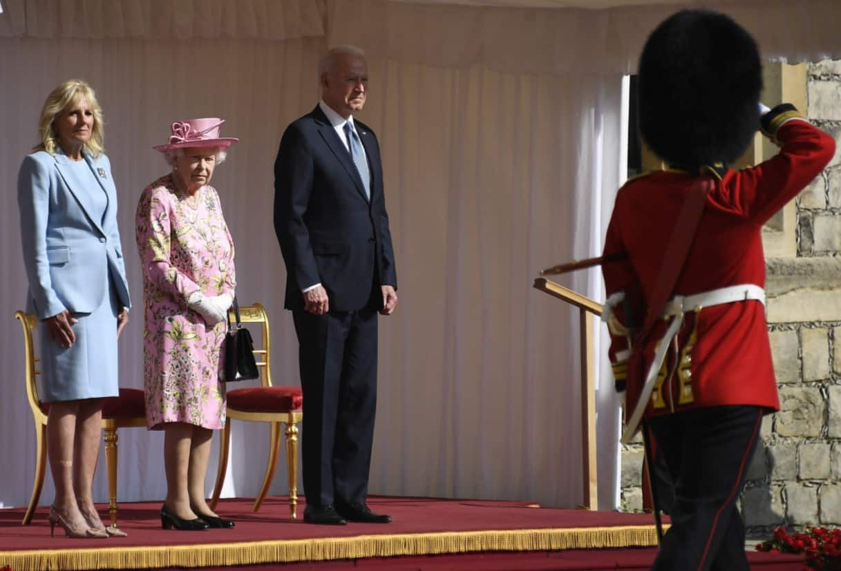 Queen Elizabeth greets Joe Biden and First Lady on the Dias as The First Battalion Grenadier Guards give a Royal Salute