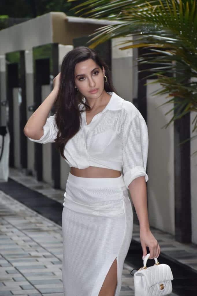 Nora Fatehi Sizzles In A Thigh High Slit White Skirt And Crop Top In
