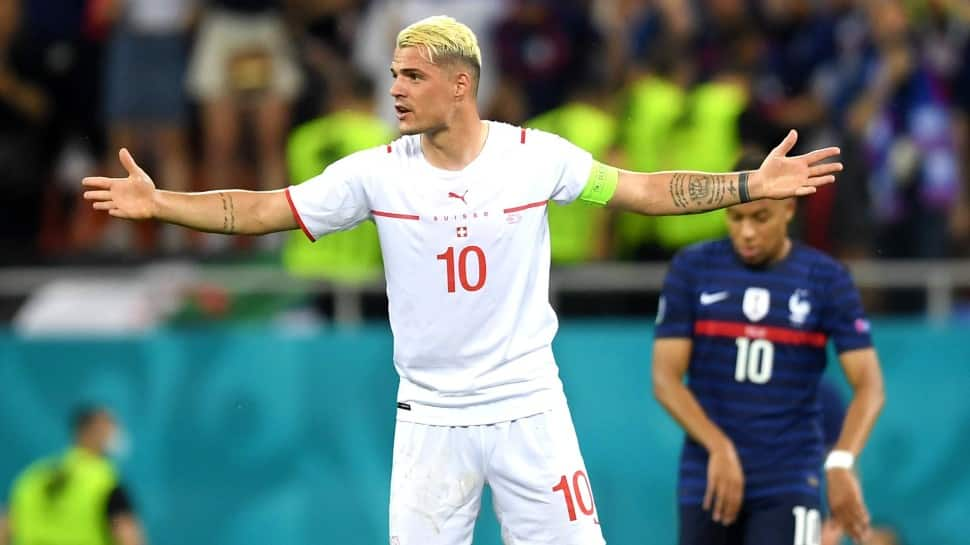 Switzerland captain Granit Xhaka exults after scoring in the penalty shootout against France in their UEFA Euro 2020 Round of 16 match. (Source: Twitter)