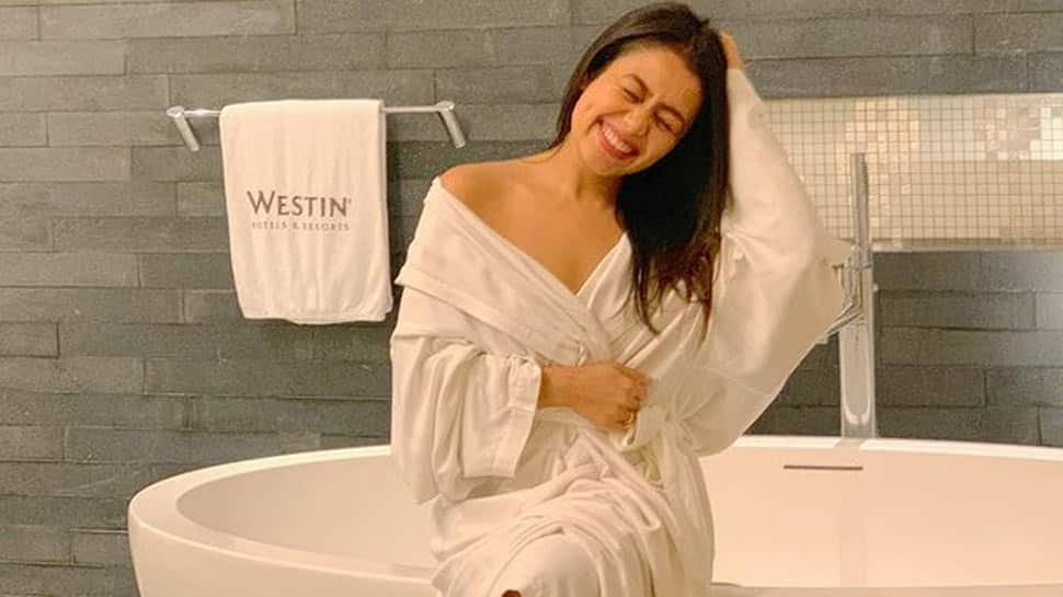 Neha Kakkar teases pics in a white bathrobe, hubby Rohanpreet Singh goes 'ahem ahem'!