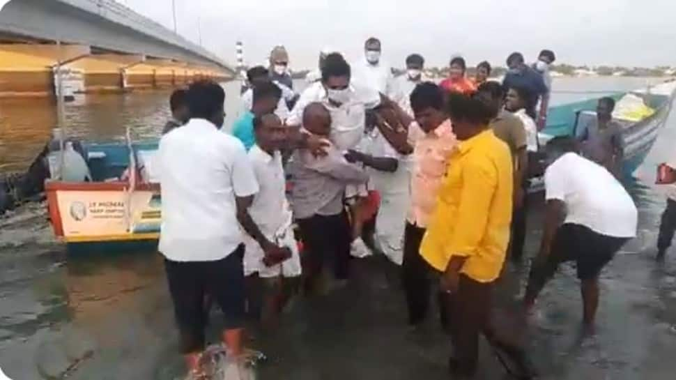 Tamil Nadu minister rides fishermen in ankle-deep water to keep white shoes, dhoti clean - Watch