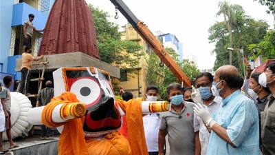 Devotees carry a statue of Lord Jagannath made of Neem wood