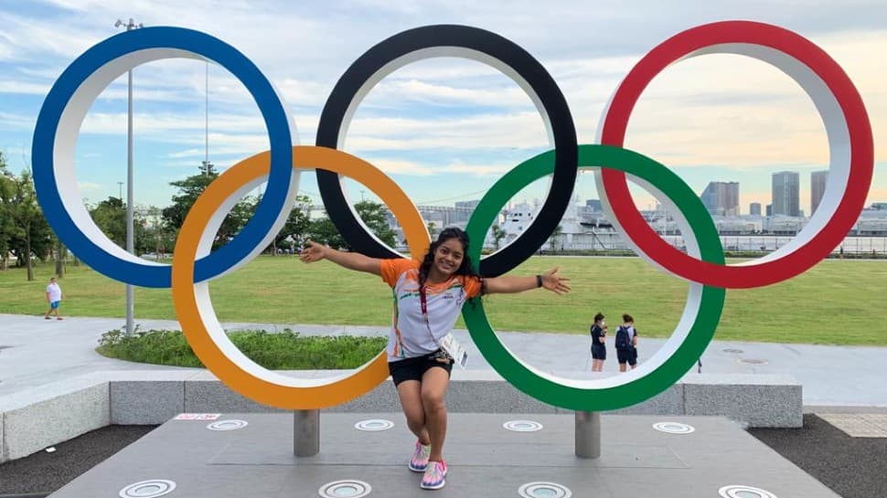 Indian gymnast Pranati Nayak poses in front of the Olympic rings in the Athletes Village in Tokyo. (Source: Twitter)
