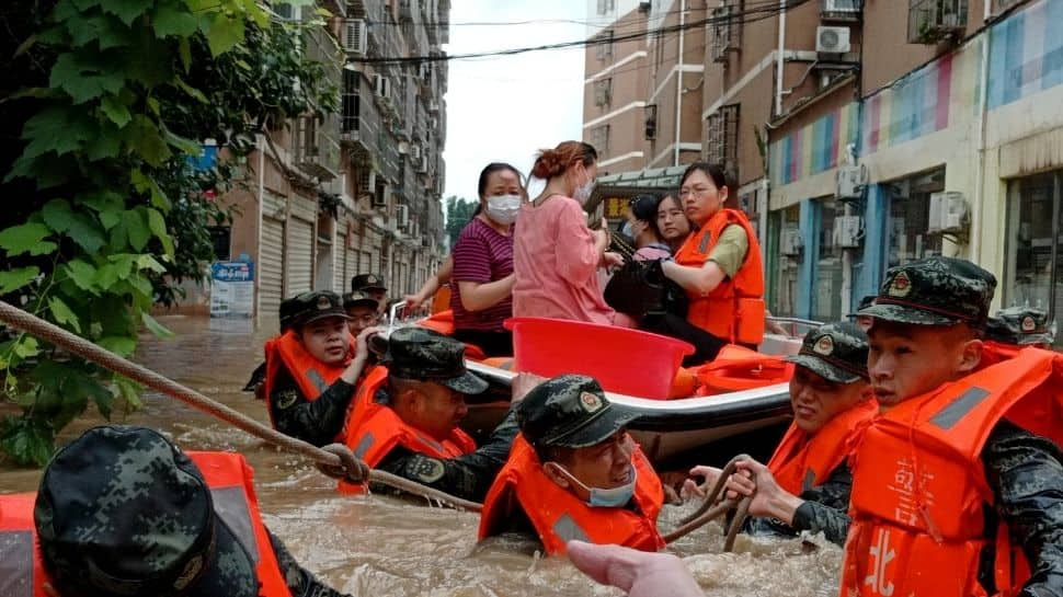 China floods: At least 21 people dead