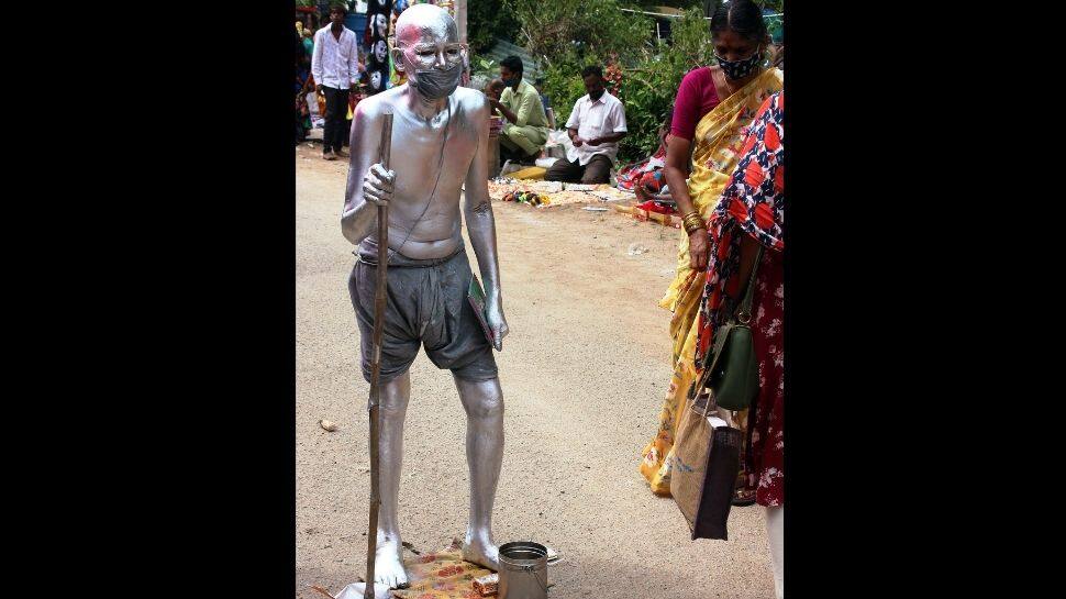 A man dressed as Mahatma Gandhi at a temple