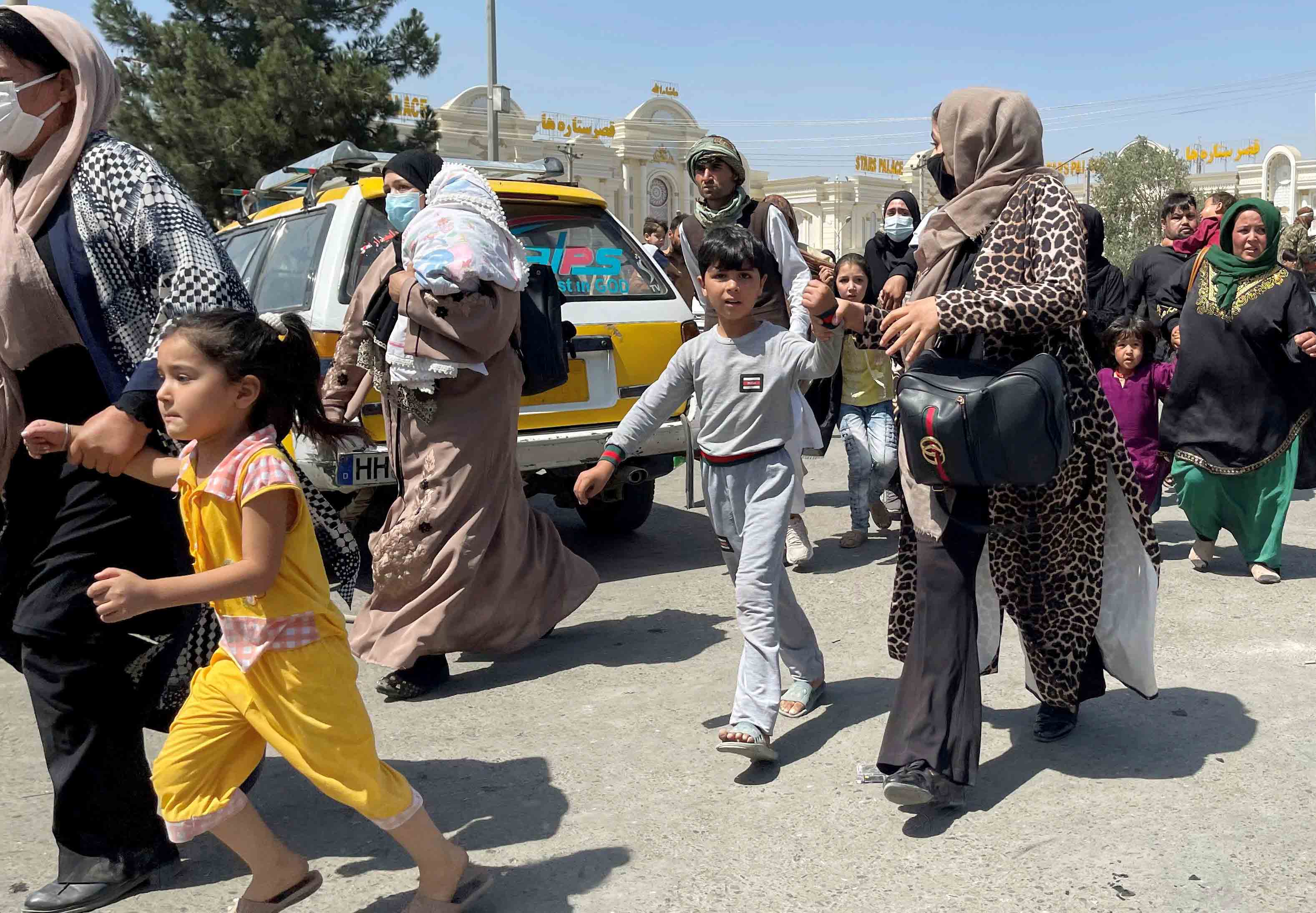 Women try to get inside Hamid airport in Kabul