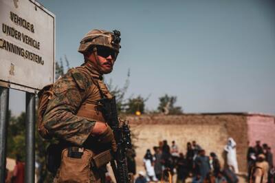 A US troop provides security during an evacuation at Hamid Karzai International Airport in Kabul