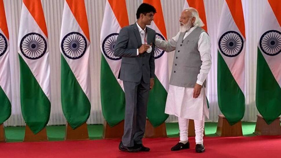 PM Narendra Modi speaking to Noida DM Suhas LY PM Narendra Modi speaking to Noida DM Suhas LY, who won silver medal for India at the Tokyo Paralympics. (Photo: ANI)