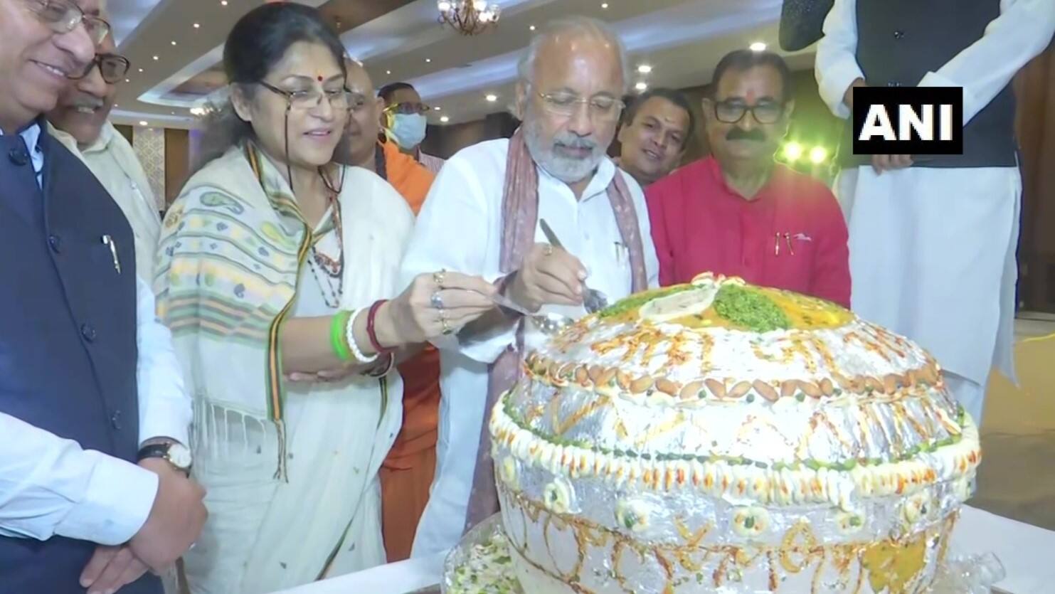 BJP workers and supporters cut a 71-kg laddu
