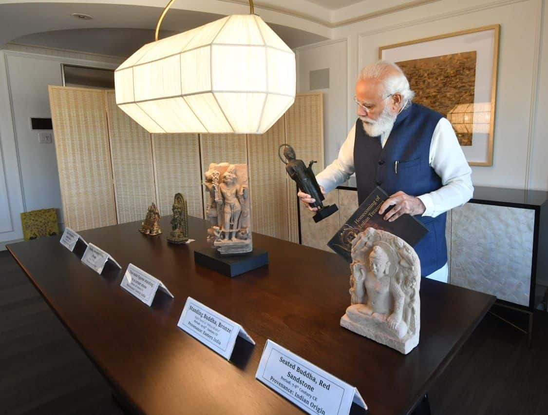 PM Narendra Modi observes artefacts 