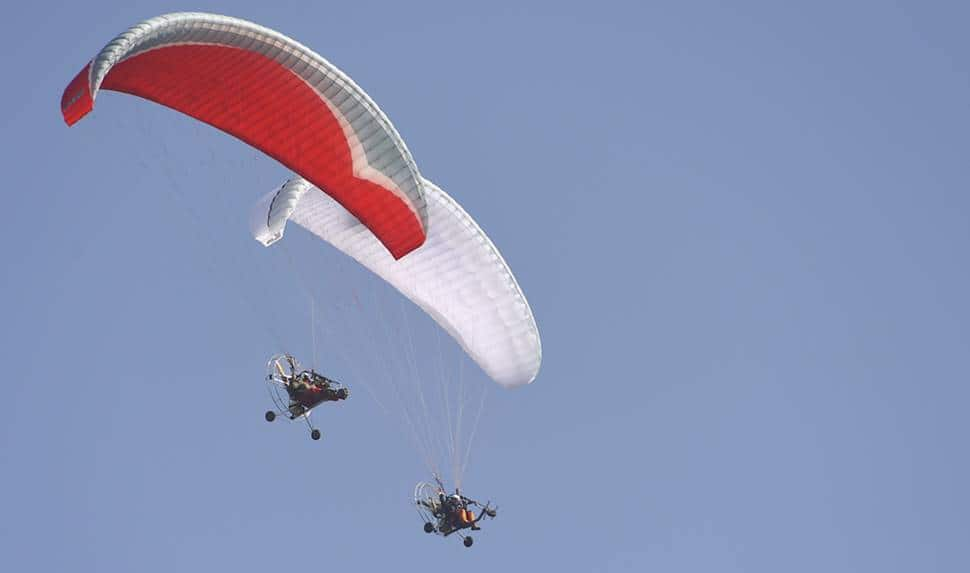 IAF members in parachutes display various formations