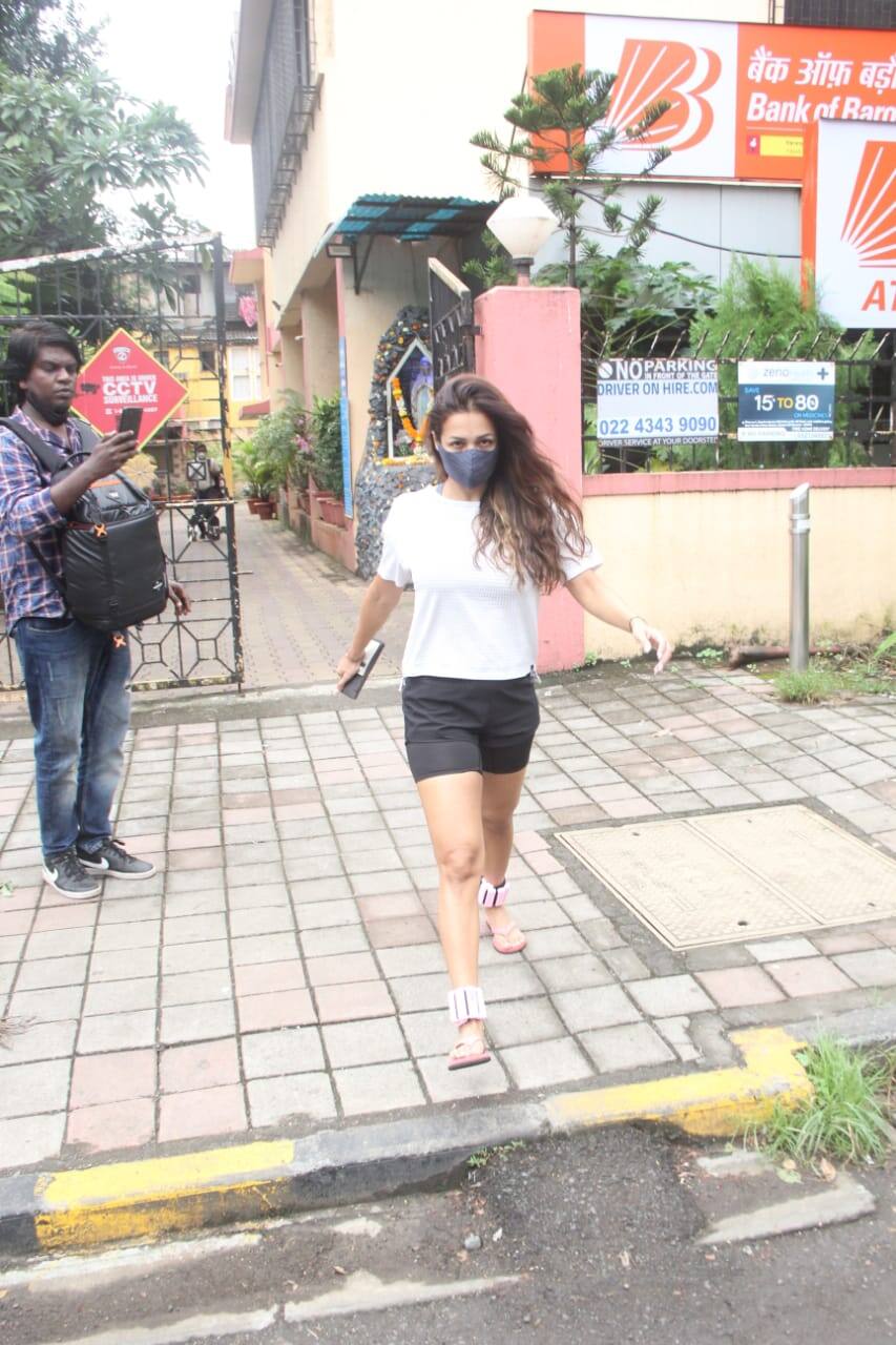 Malaika wears plain white t-shirt with black shorts