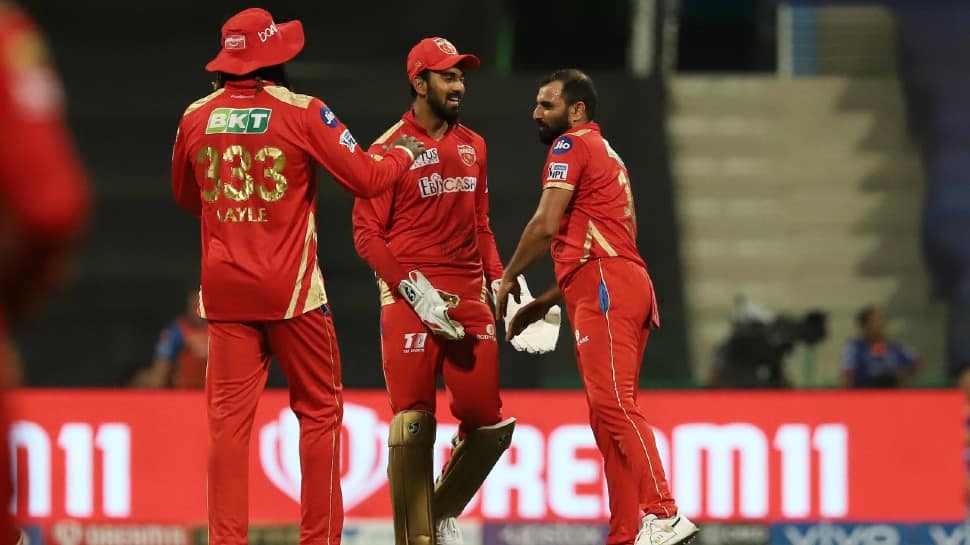 Punjab Kings paceman Mohammed Shami (right) celebrates after picking up a wicket against Mumbai Indians in their IPL 2021 match. (Photo: ANI)