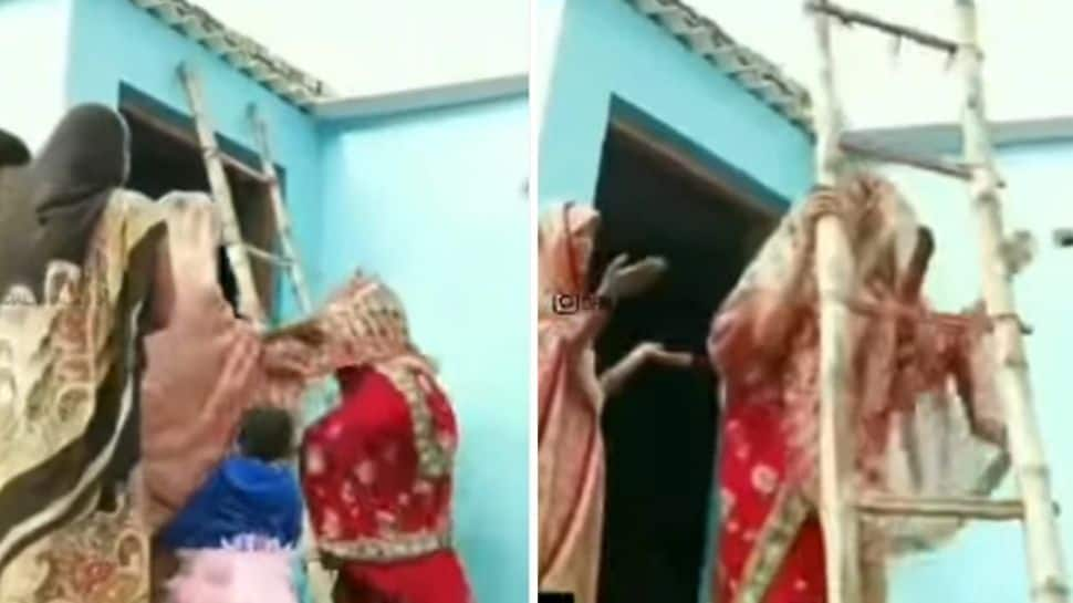 Viral video: Furious bride climbs a ladder, refuses to come down from roof - watch