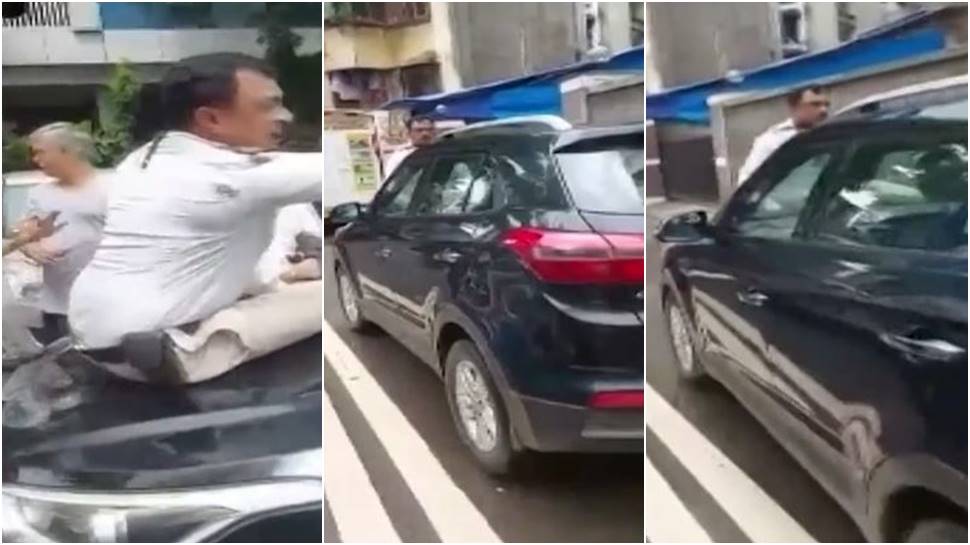 Cop sits on car bonnet to stop traffic violator, man drives off to dodge fine - Watch