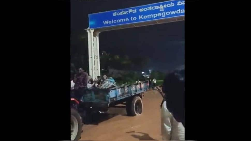 Passengers ferried on tractor to catch flight as heavy rains flood karnataka Kempe Gowda airport - Watch 