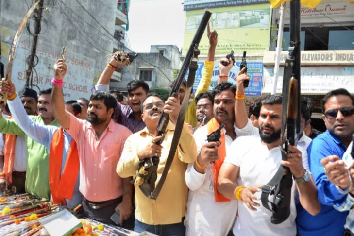 Members of Hindu Utsav Samiti display weaponry