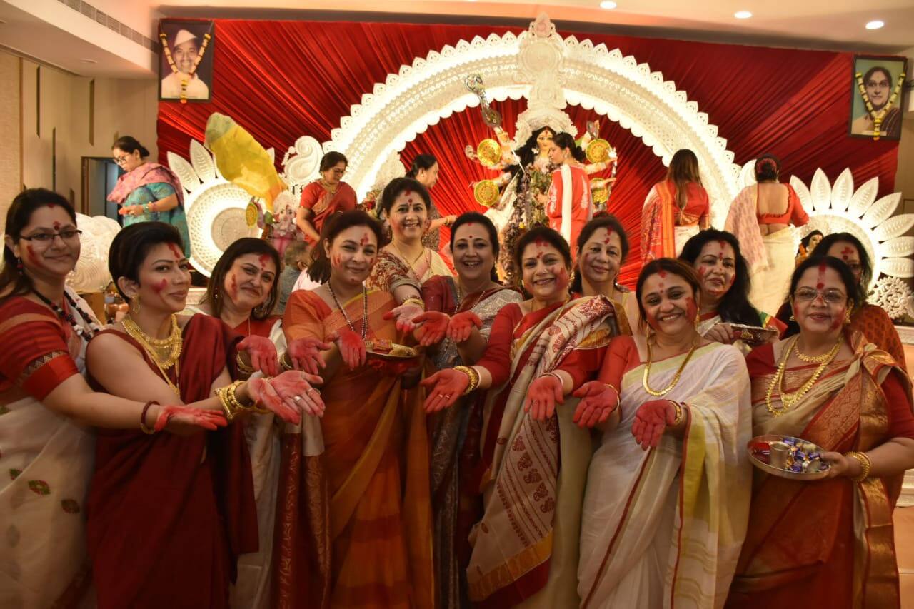Sharbani Mukherji poses with women at Durga puja