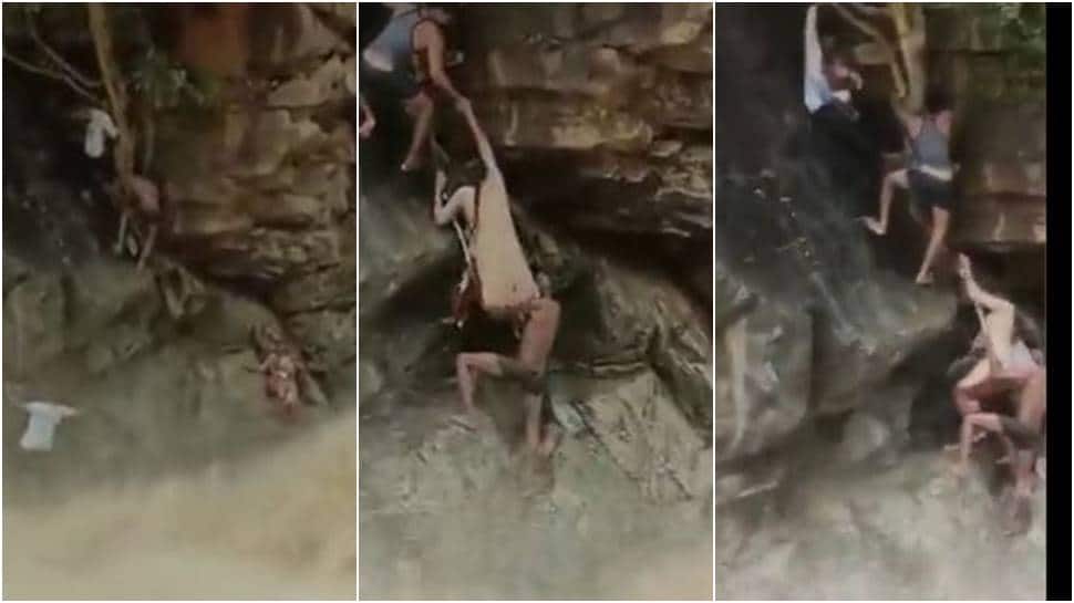Tamil Nadu forest officials brave raging waterfall to rescue trapped woman and infant - WATCH