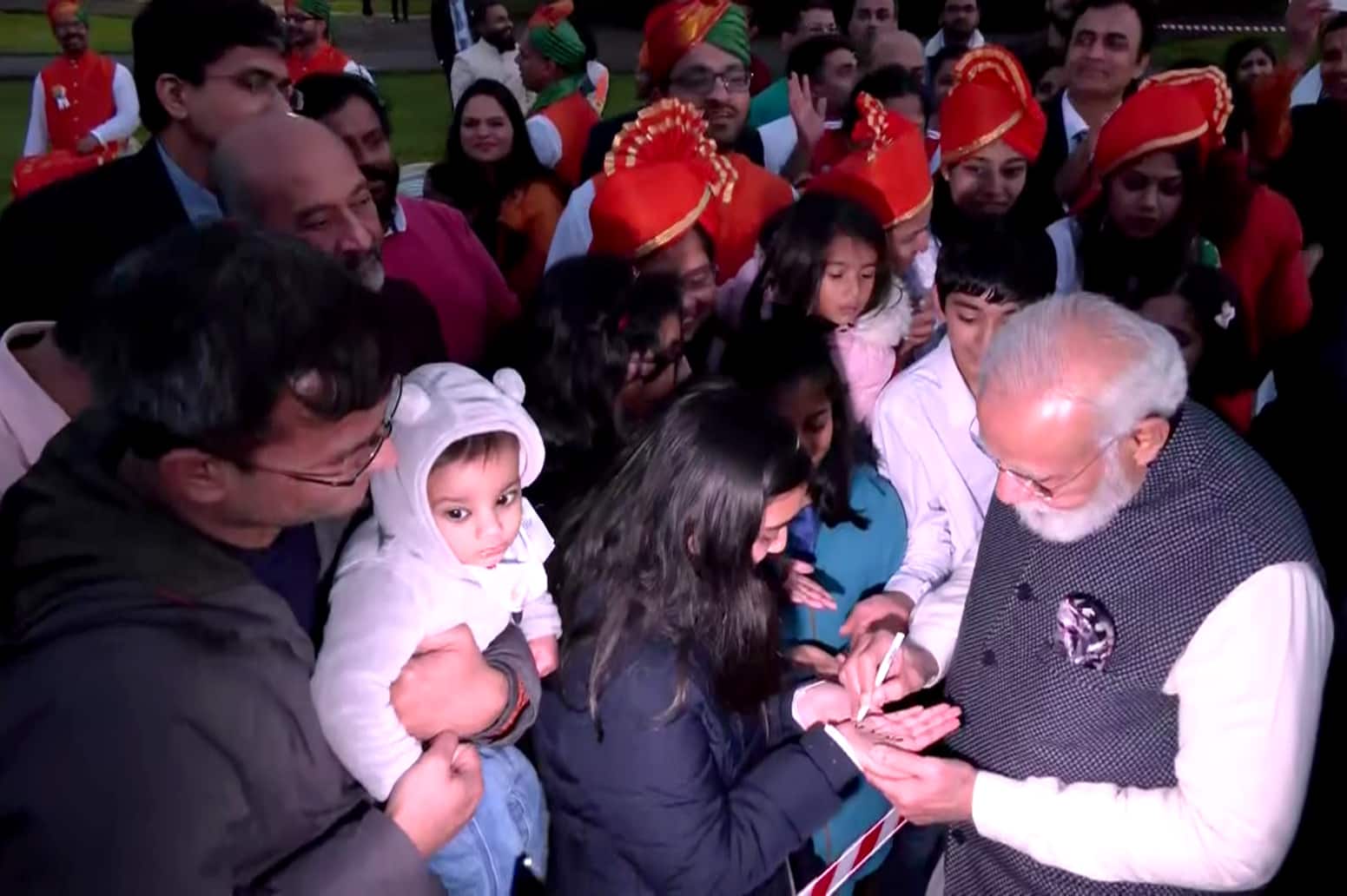 PM Narendra Modi giving autograph to a girl 