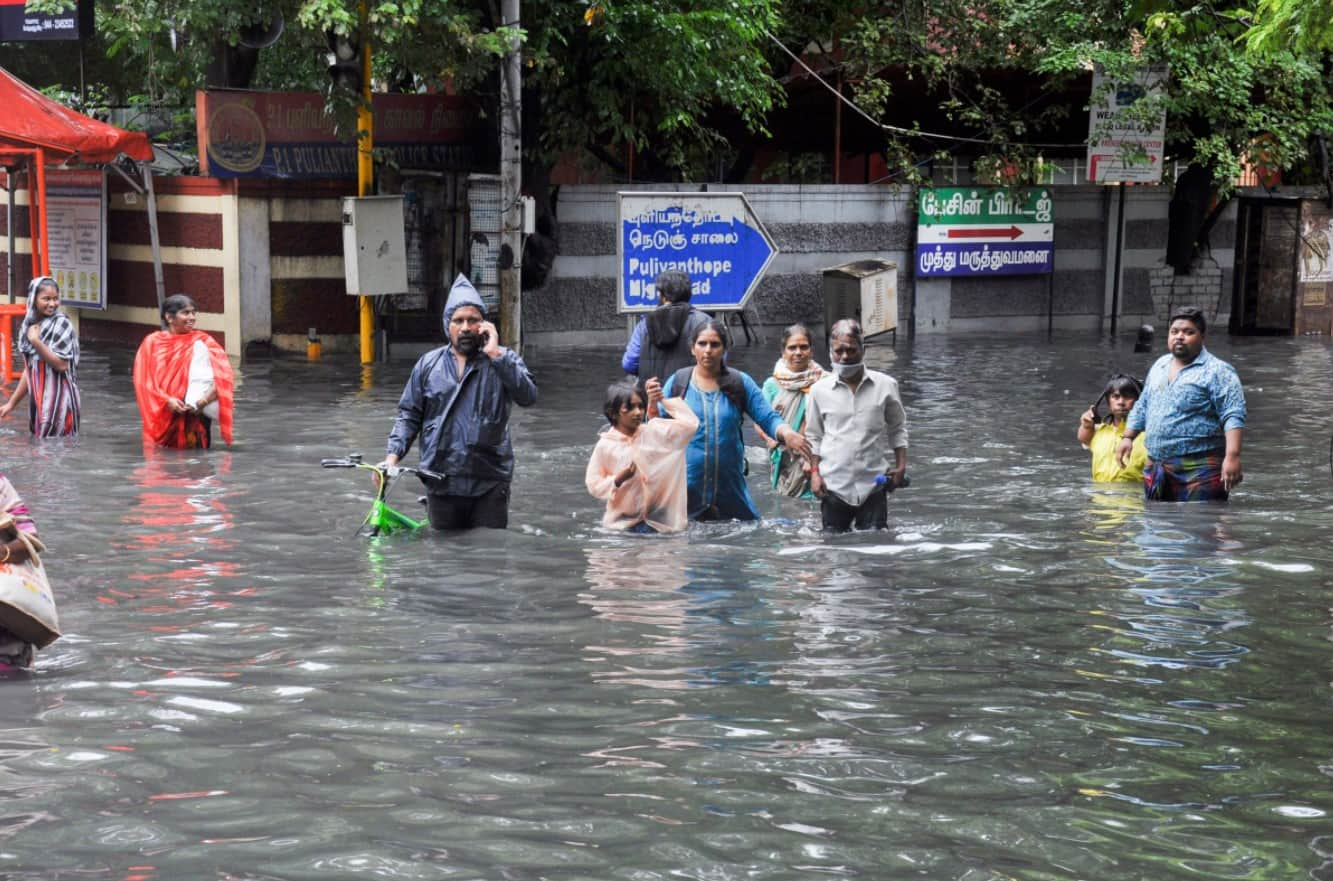 Commuters wading through a waterlogged area